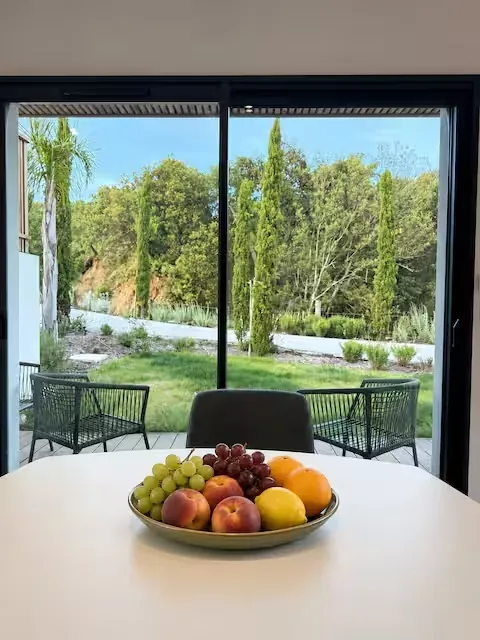 Dining table with a fruit bowl and garden view – L’Annexe du Domaine de la Subérine